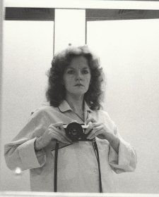 1/2 length self portrait in mirror, wearing pyjama shirt, camera at shoulder height, 1979 Carol Jerrems