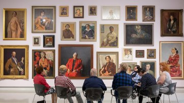 People viewing portraits in Gallery One