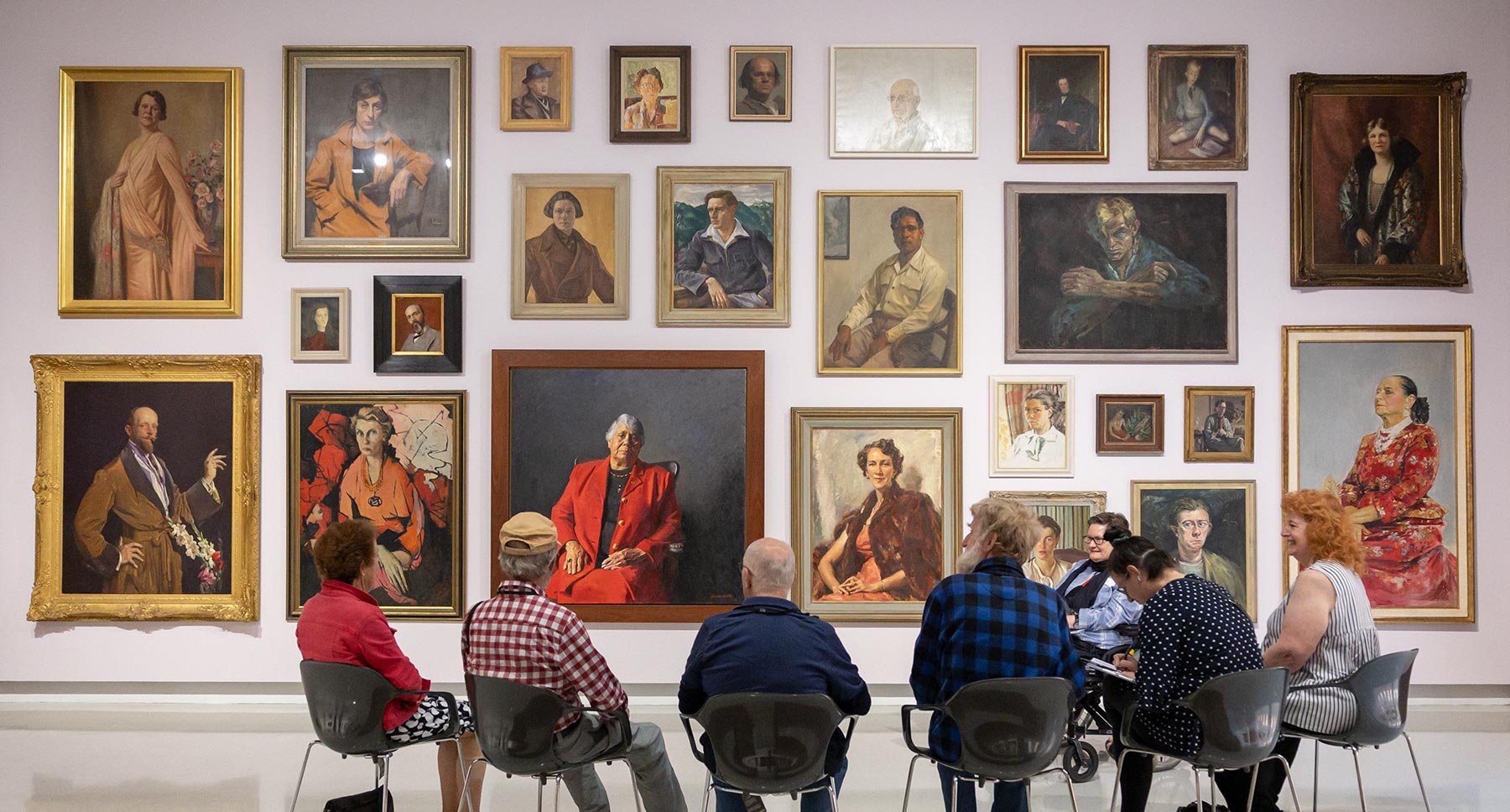 People viewing portraits in Gallery One