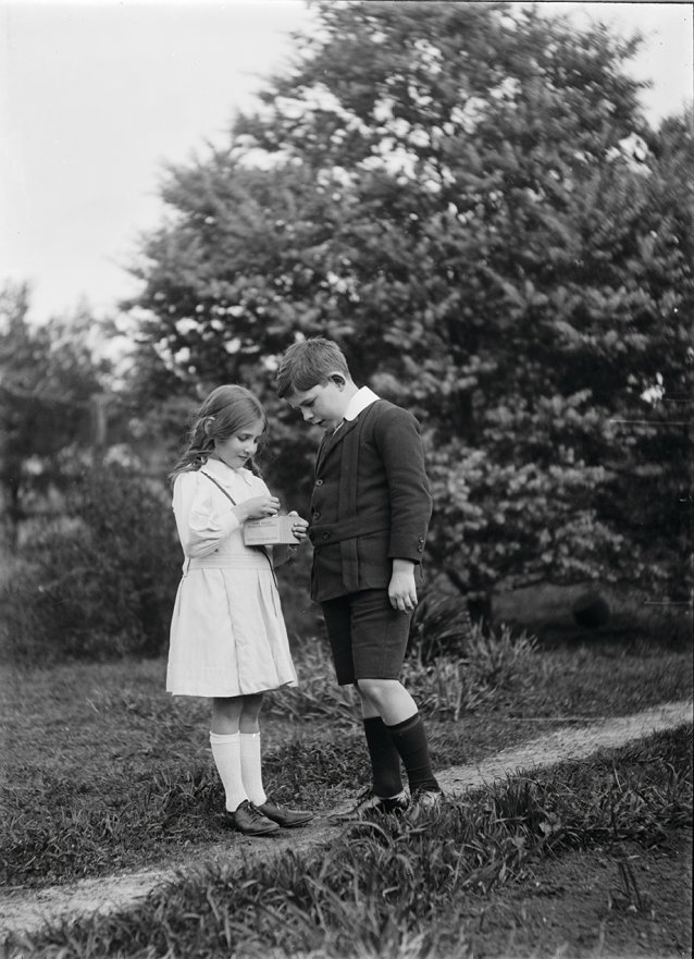 Boy and Girl looking at box in girl's hand