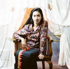 Potret diri di depan kelambu terbuka (Self portrait before the open mosquito net), 2009 by Herra Pahlasari