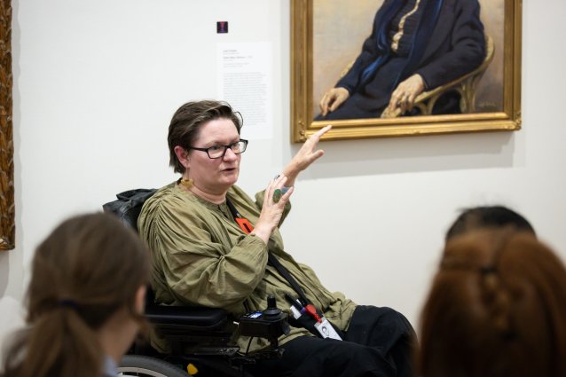 A learning facilitator wearing a red badge