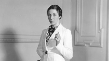 Amy Johnson wearing a woollen suit from the collection of flight clothes designed by Madame Schiaparelli for her solo flight from London to Cape Town, 1938 unknown photographer